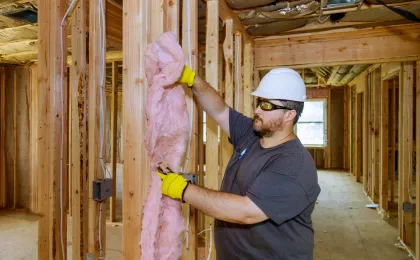 Home remodeling contractor in Los Angeles CA installing insulation and wood framing during construction