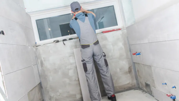 Bathroom remodeling contractor in Los Angeles CA installing wall tiles for modern shower renovation