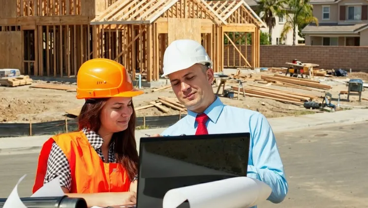 General contractor in Los Angeles CA reviewing construction plans and managing residential building project on site