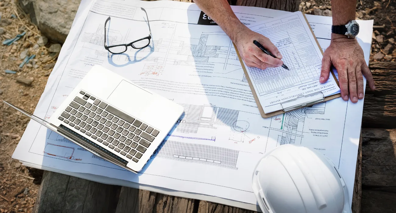 General contractor in Los Angeles planning construction with blueprints and site management